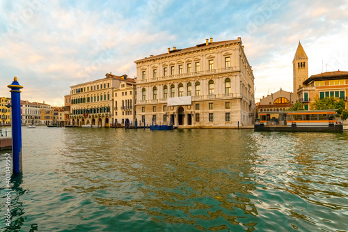 Beautiful panorama of the Grand Canal during a summer day with blue sky and clouds. In the background the Palazzo Grassi in the Venetian lagoon, Venice, Italy.