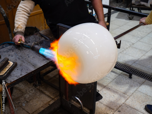 Amazing creation of a work of art from molten glass. The blue flame photo