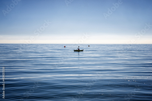 Minimalistic picture of kayak on the sea in M  laga  Spain. Relaxing sport in tranquil water.