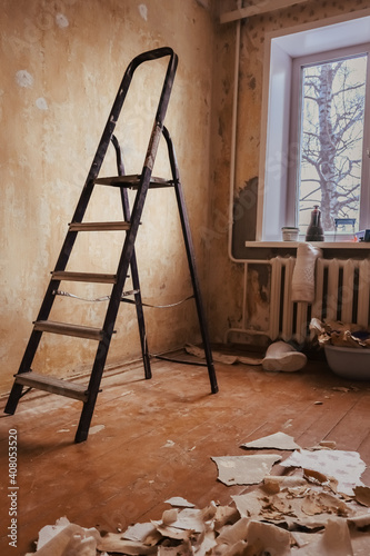 stepladder in a room with wallpaper removed. retro room. the concept of renovation and remodeling of an old apartment