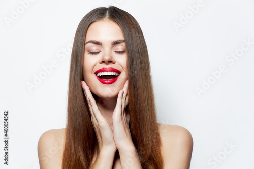 Sexy woman Laughs and touch his face with his hands red lips isolated background