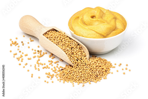 Photo Mustard seeds in the wooden scoop and mustard sauce in the bowl