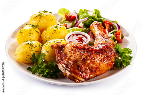 Roast chicken leg with boiled potatoes on white background
