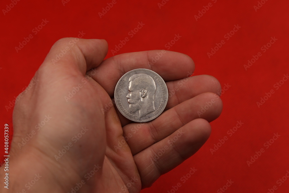 Old Russian silver coin one ruble in hand Old Russian silver coin one ruble in hand