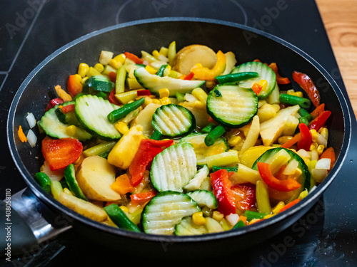 Mix of vegetables cooking in frying pan
