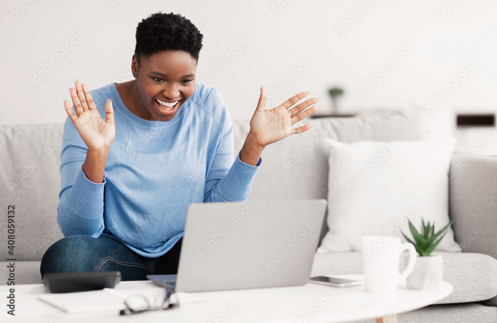 Black woman having video call using laptop and talking Black woman having video call using laptop and talking