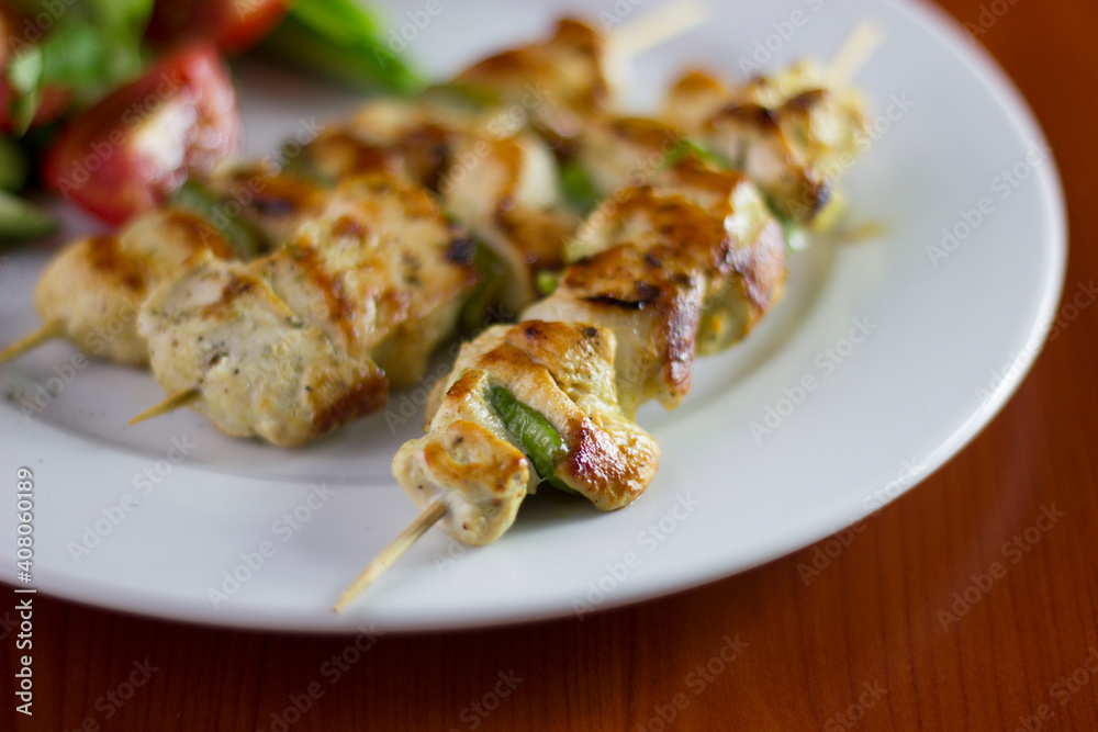 Chicken shish kebab, grilled chicken with greens and tomato