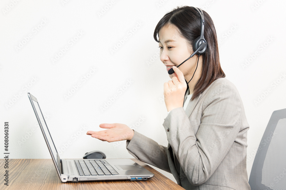 Woman wearing a headset and having a web conference Woman wearing a headset and having a web conference