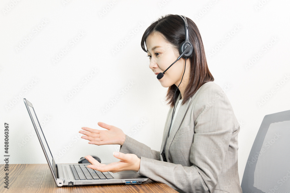 Woman wearing a headset and having a web conference Woman wearing a headset and having a web conference