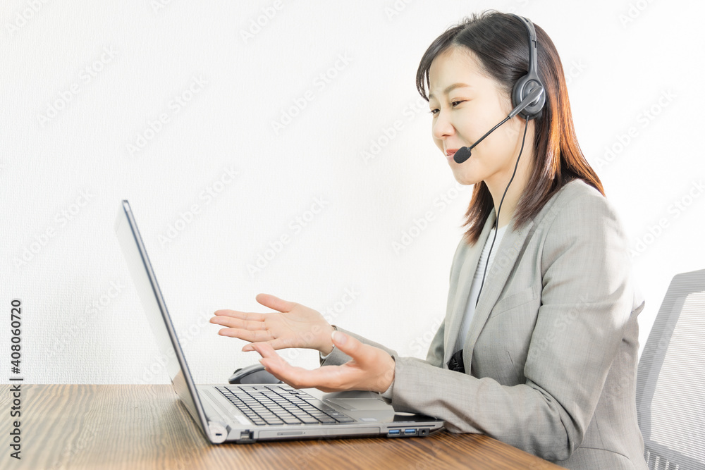 Woman wearing a headset and having a web conference Woman wearing a headset and having a web conference