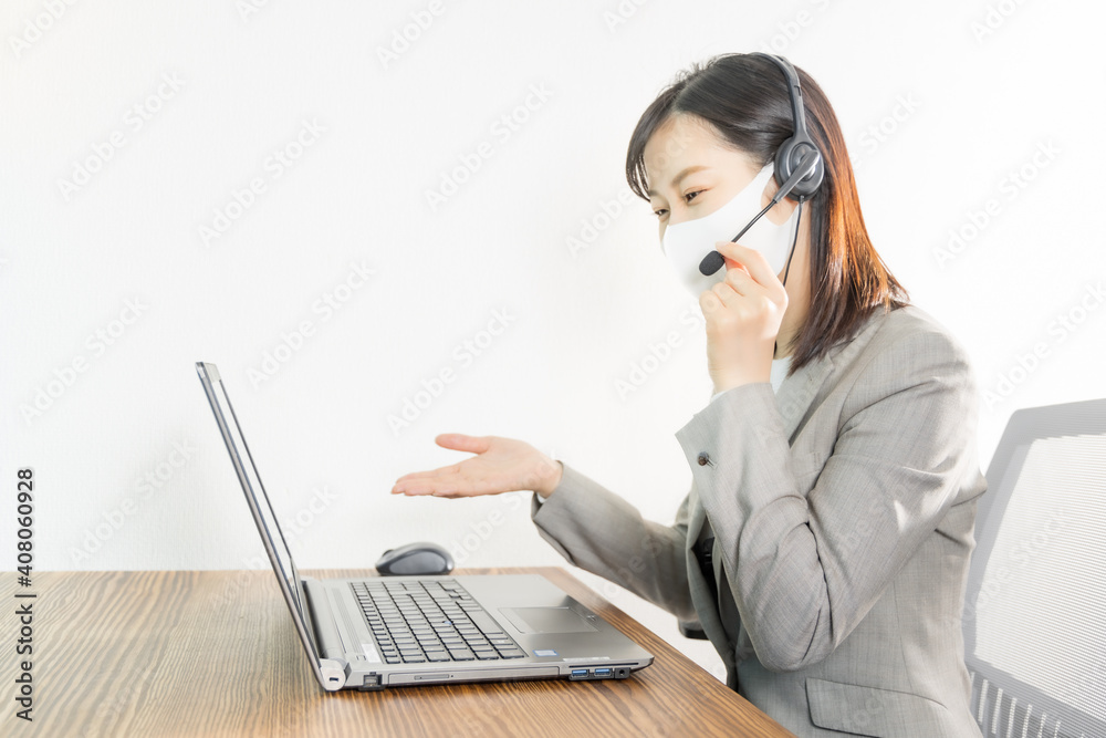 Woman wearing a headset with mask and having a web conference Woman wearing a headset with mask and having a web conference