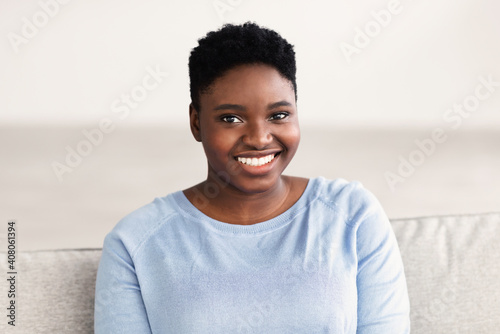 Portrait of casual young black woman smiling confidently