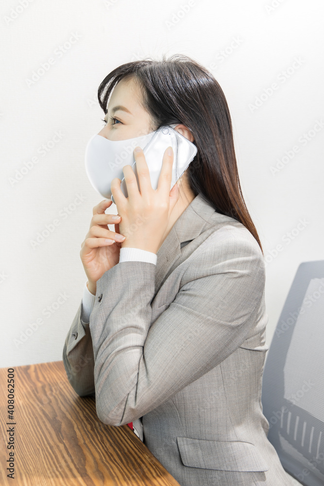 Woman wearing a mask calling for work with a smile