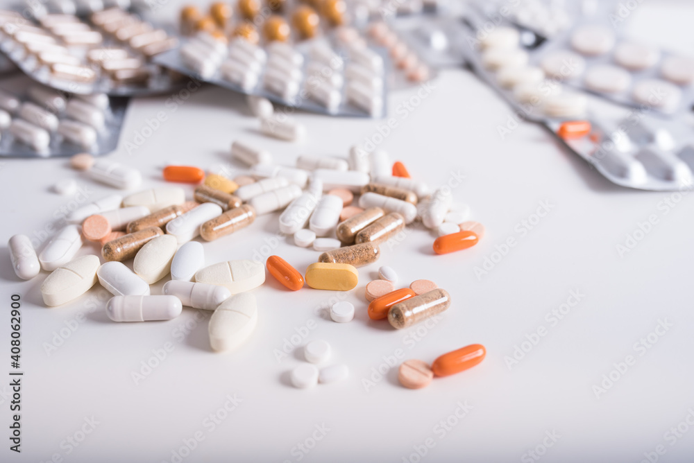 Different kind of pills and capsules on white background. Pharmaceutical packaging with drugs and pills. Concept of medicine. Different kind of pills and capsules on white background. Pharmaceutical packaging with drugs and pills. Concept of medicine.