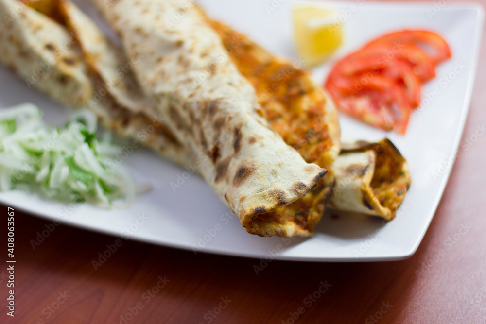 Traditional Turkish pizza (lahmacun) in a white plate Traditional Turkish pizza (lahmacun) in a white plate