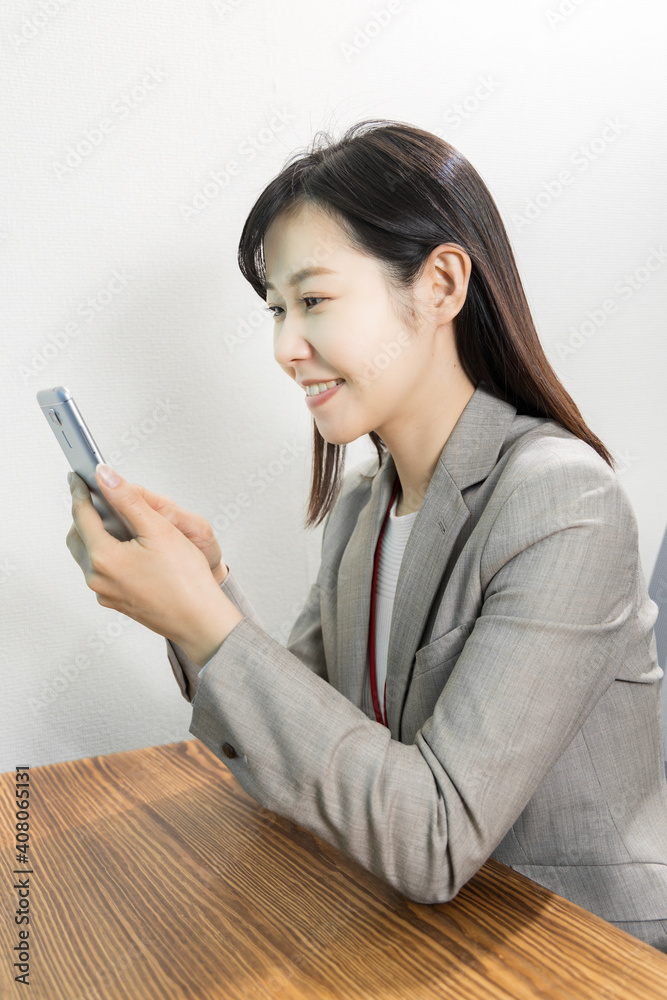 Woman uses a mobile phone at work Woman uses a mobile phone at work