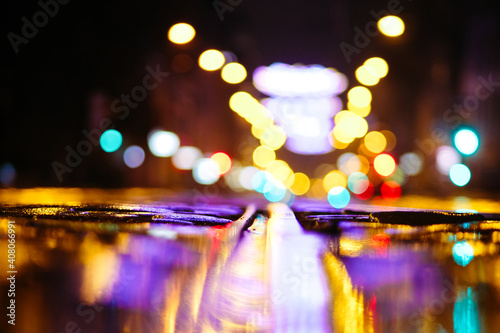 Beautiful night city lights and traffic lights, public transportation in night. Blurred background. Selective focus