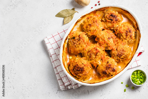 Baked meatballs with garlic tomato sauce in a baking dish. Space for text, top view.