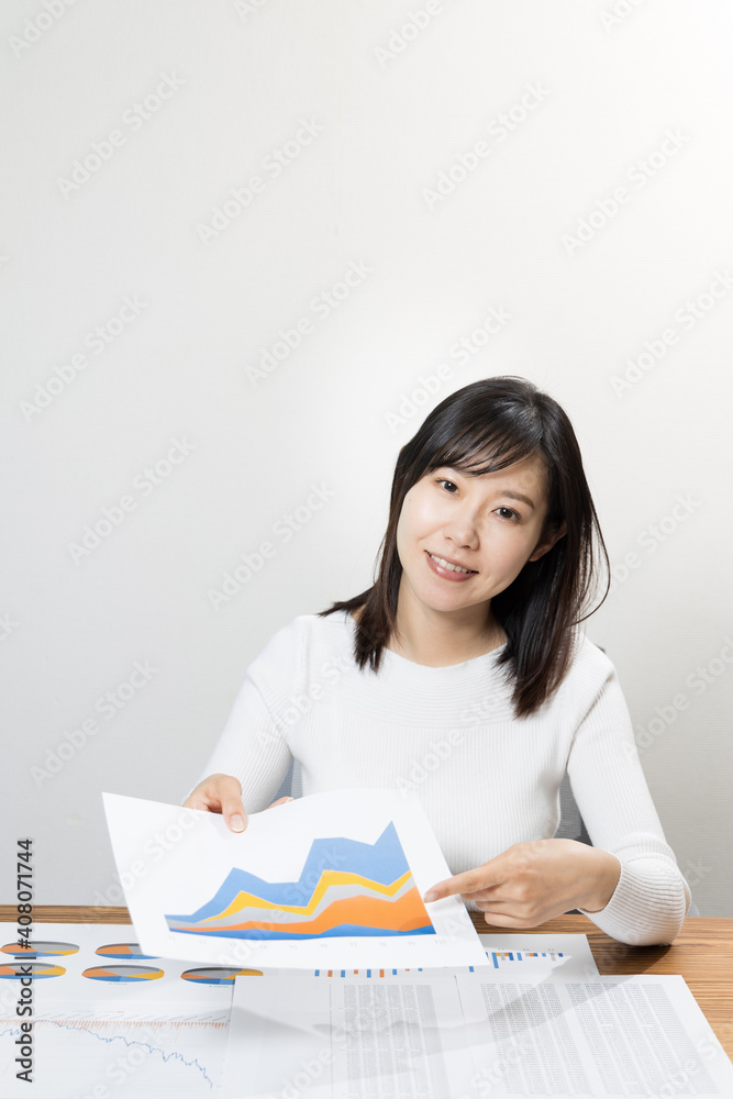 Woman talking with materials at a meeting Woman talking with materials at a meeting