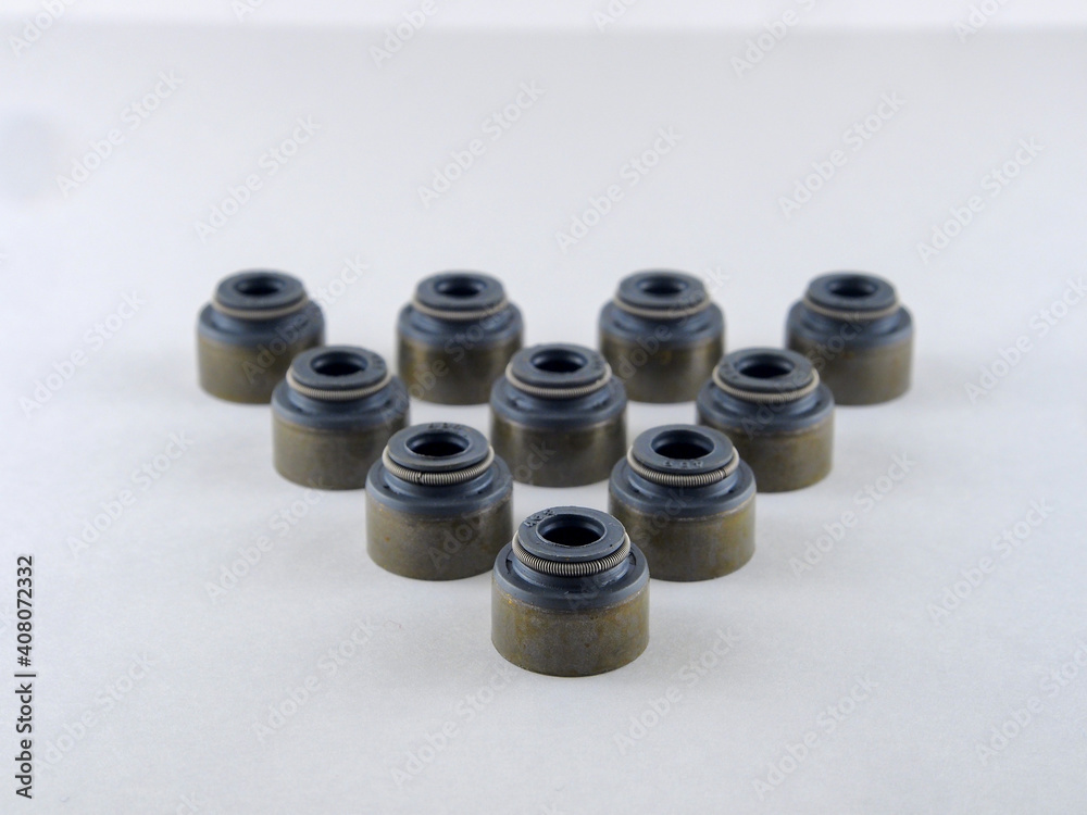 Formation, automobile oil-removing caps, lined up in rows on a white isolated background. Car spare parts, close-up. Formation, automobile oil-removing caps, lined up in rows on a white isolated background. Car spare parts, close-up.