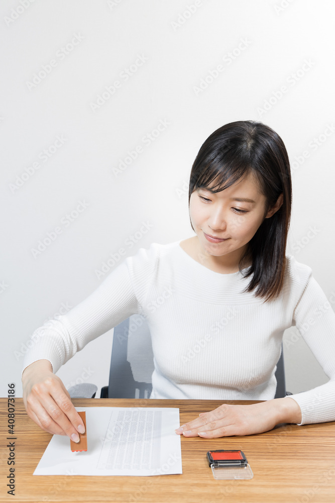 Woman stamping a name seal Woman stamping a name seal