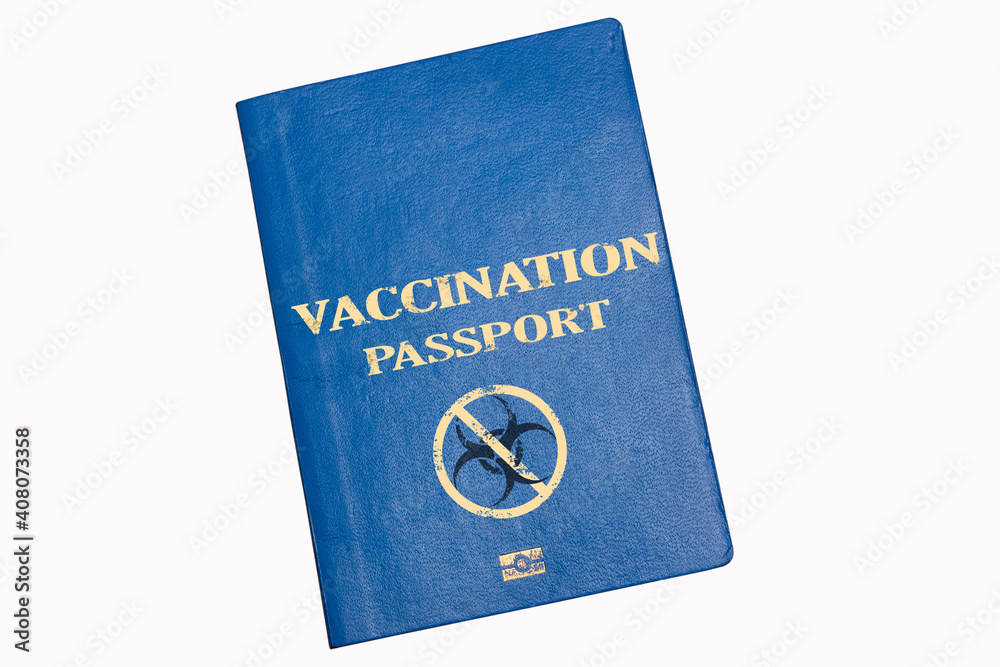 Blue biometric passport on a white background with the inscription VACCINATION PASSPORT and danger biohazard caution sign. Concept of introducing a vaccination passport or immunity Blue biometric passport on a white background with the inscription VACCINATION PASSPORT and danger biohazard caution sign. Concept of introducing a vaccination passport or immunity