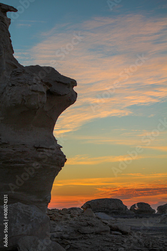 Sun rising in the Libyan desert, uncovering bizarre limestone formations, near Farafra in Egypt