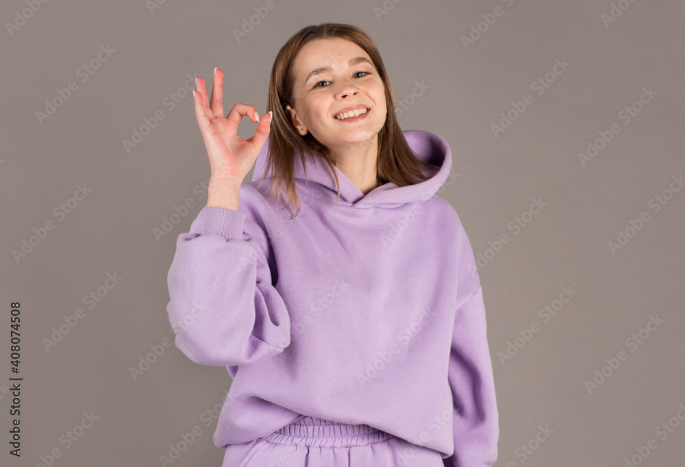 Portrait of cheerful happy brunette woman gesturing OK Portrait of cheerful happy brunette woman gesturing OK
