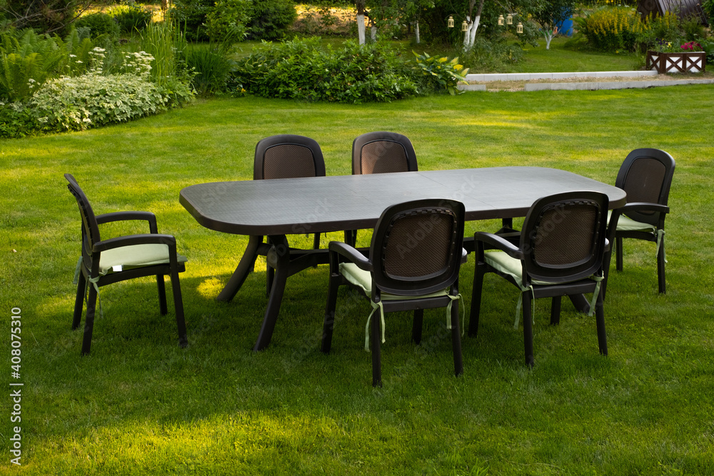 Table and chairs in garden. Selective focus Table and chairs in garden. Selective focus
