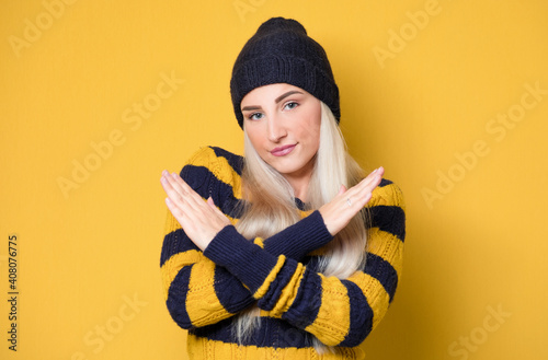 Young woman gesturing stop sign with palm of hand,refuses or reject something, isolated on white background