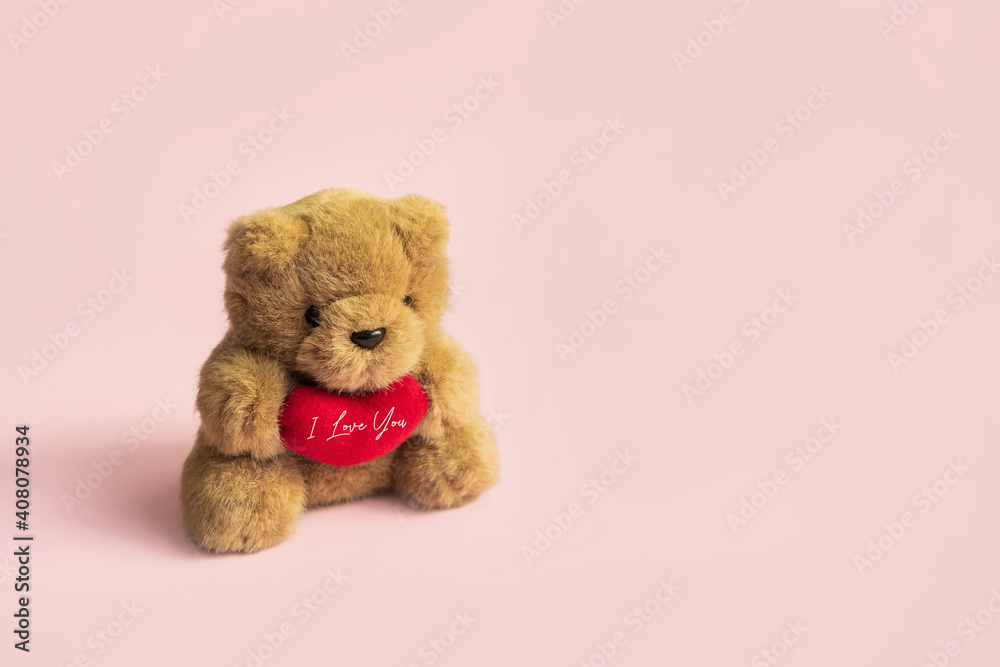 Cute teddy bear with red heart on pastel color background and copy space, Valentine's Day concept