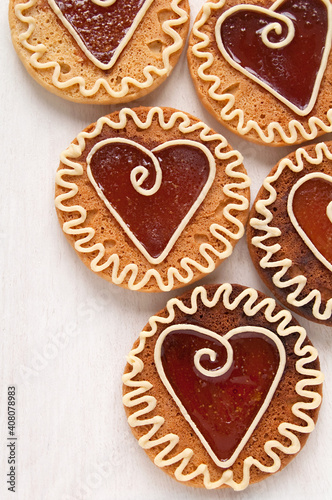 Homemade cookies with caramel in the center of the heart shaped, ornament with white chocolate