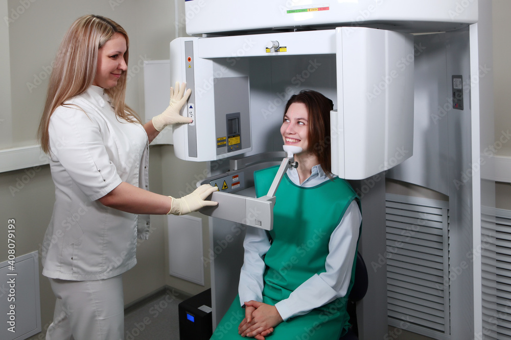 Dentist doctor prepares the patient to take x-rays of the teeth. X-ray of teeth in a dental clinic. Modern dentistry. X-ray equipment. The concept of treatment and prevention of dental diseases. Dentist doctor prepares the patient to take x-rays of the teeth. X-ray of teeth in a dental clinic. Modern dentistry. X-ray equipment. The concept of treatment and prevention of dental diseases.