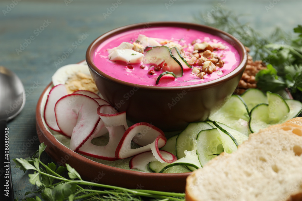 Delicious cold summer beet soup on blue wooden table, closeup Delicious cold summer beet soup on blue wooden table, closeup