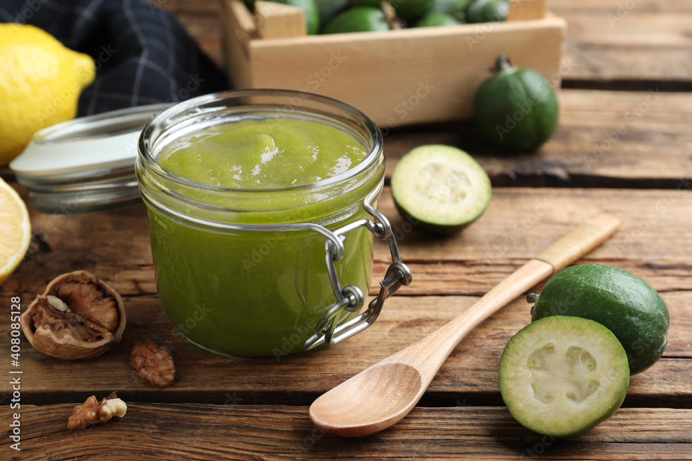Feijoa jam in glass jar on wooden table
