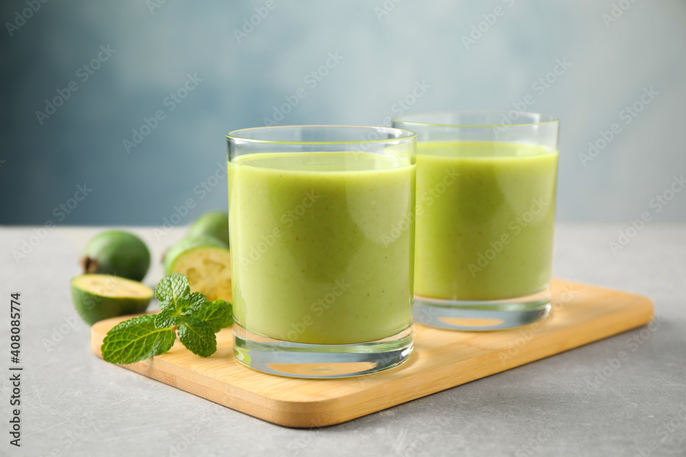 Fresh feijoa smoothie and fresh mint on grey table, closeup Fresh feijoa smoothie and fresh mint on grey table, closeup