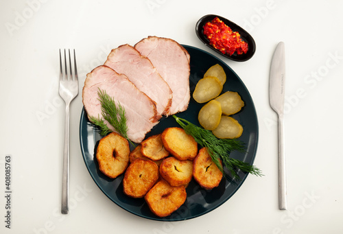 Ordinary farmers food: fried potatoes, ham, cucumber, peppers on plate photo