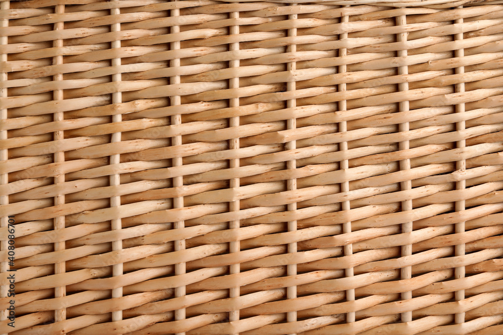Handmade wicker basket made of natural material as background, closeup view Handmade wicker basket made of natural material as background, closeup view