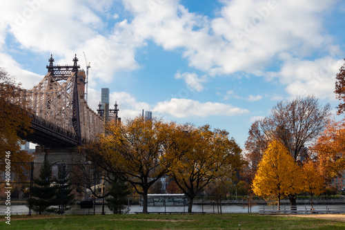 Queensbridge Park in Long Island City Queens New York during Autumn with Colorful Trees and the Queensboro Bridge © James