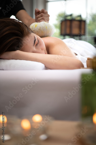 Portrait of young beautiful asian woman enjoys massage in a luxury spa resort