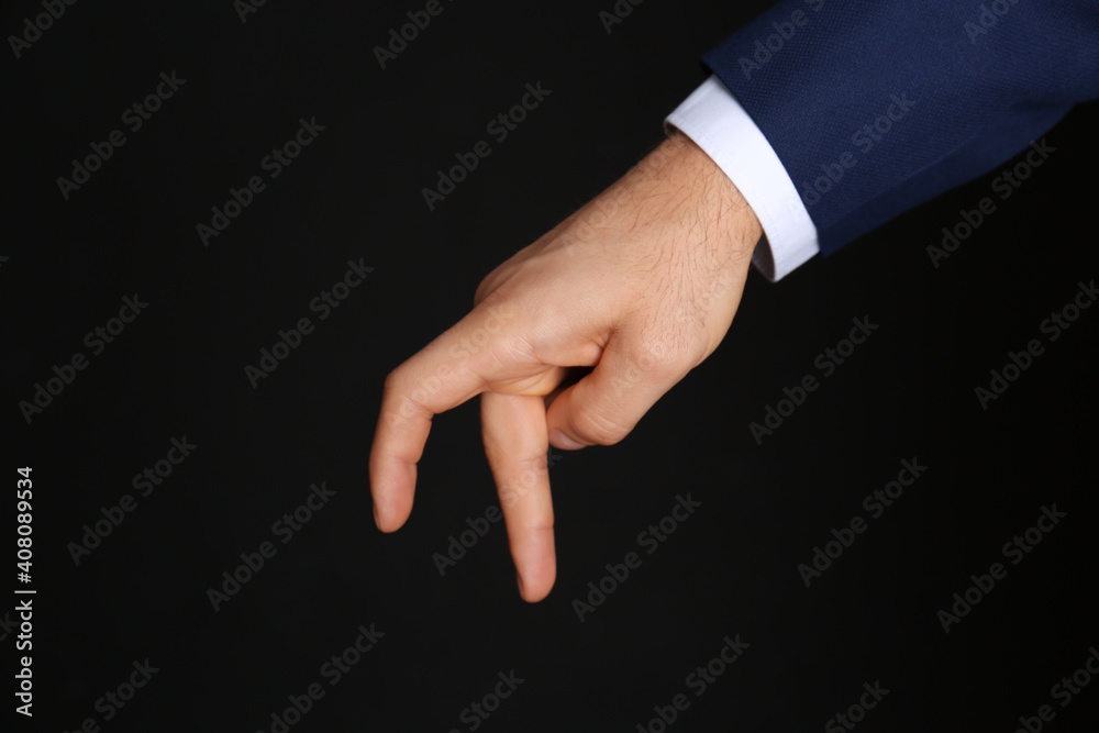 Businessman imitating walk with hand on black background, closeup. Finger gesture