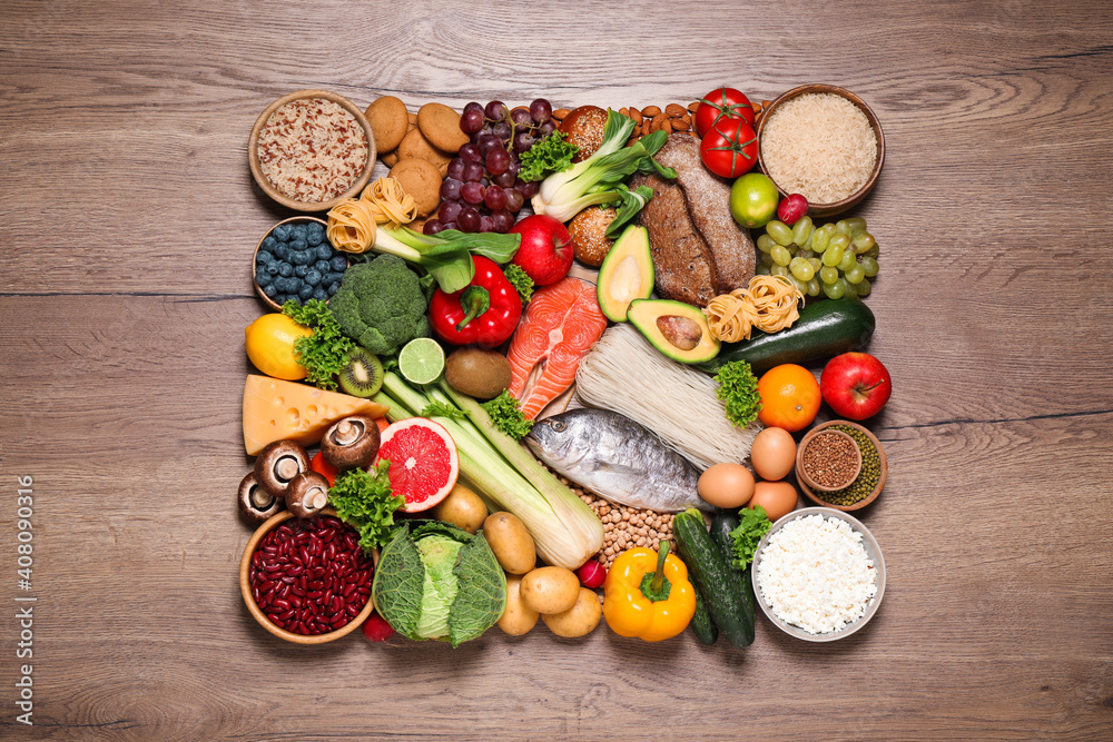 Different products on wooden table, top view. Healthy food and balanced diet Different products on wooden table, top view. Healthy food and balanced diet