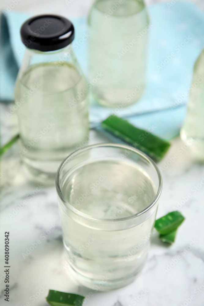 Fresh aloe drink on white marble table Fresh aloe drink on white marble table