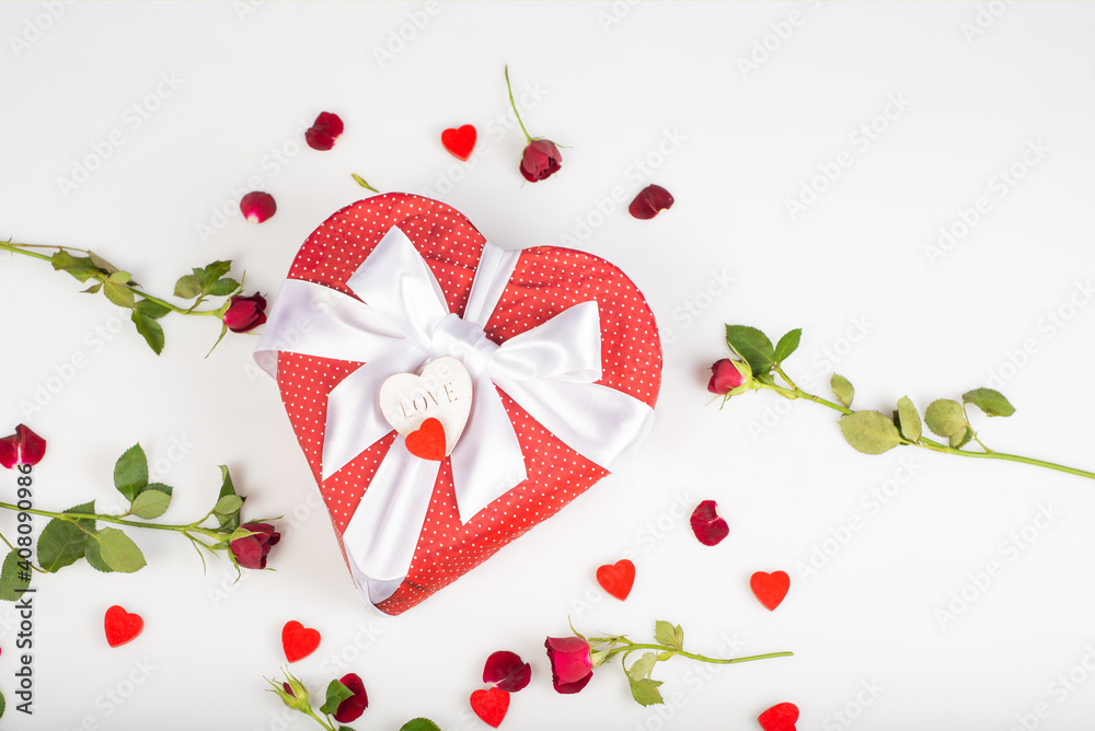 Gift box shape of a heart with bow isolated on white background with red roses and decorative heart. Wooden decorative hearts. Gift box shape of a heart with bow isolated on white background with red roses and decorative heart. Wooden decorative hearts.