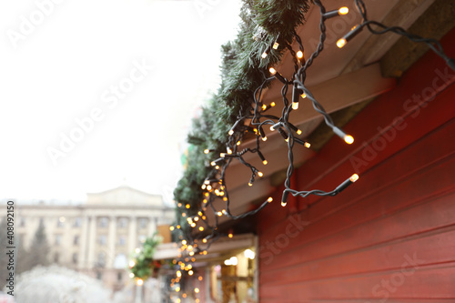 Christmas fair stall with string lights outdoors, closeup