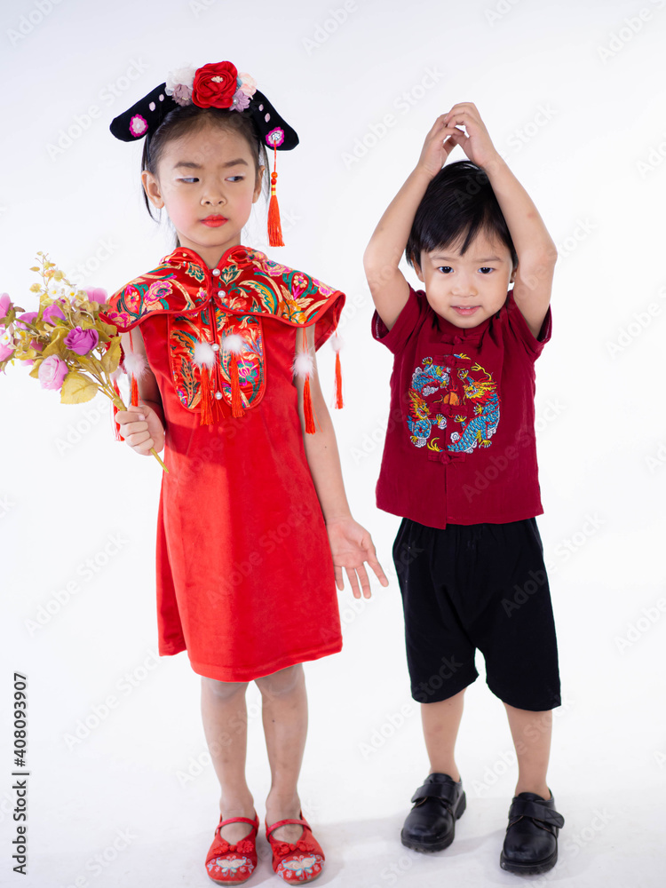 Happy Chinese new year. Asian boy in cheongsam of traditional chinese dress on white background. Happy Chinese new year. Asian boy in cheongsam of traditional chinese dress on white background.