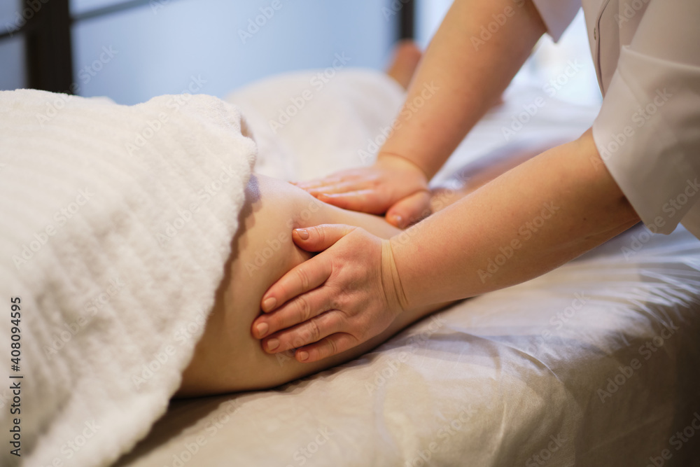 Body care concept. Special anticellulite treatment. Masseur makes anticellulite massage young woman in spa salon. Close up view