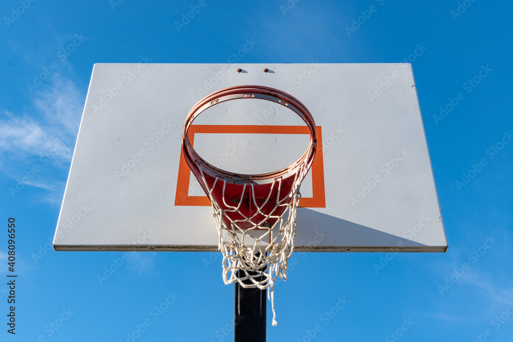 Playground basketball hoop with torn net