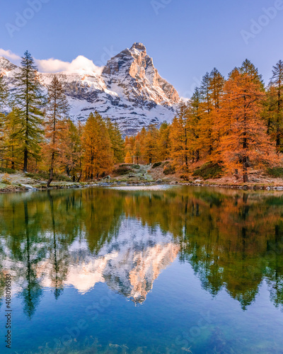 Blue Lake and the surroundings area during the fall and changing of the colors. Foliage, reflection and snowy peaks.