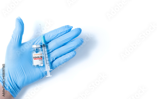 Doctor or scientist hand in blue nitrile gloves holding flu, measles, coronavirus vaccine shot for diseases outbreak vaccination isolated
